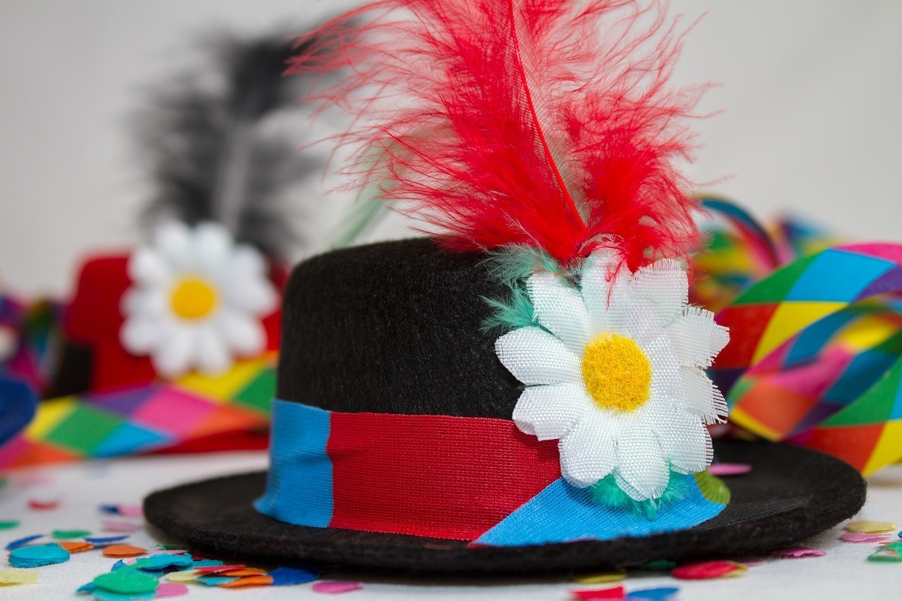 hat with red feather and flower